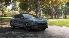 A new Ford Mustang Mach-E on a scenic residential road