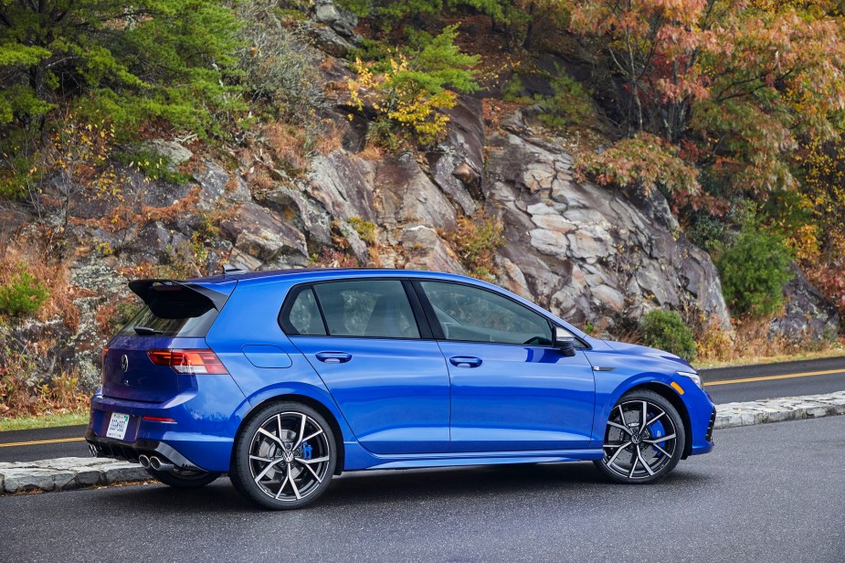 A bright blue Volkswagen Golf has a sharp profile. 