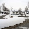 A group of campers parked in the snow, potentially winterizing your camper if parked here would be a good idea.