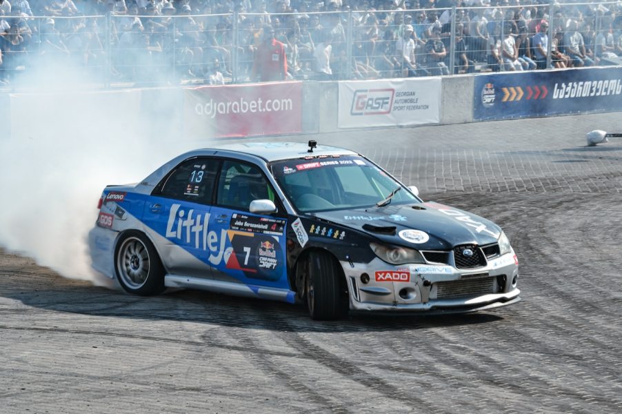 A silver Subaru WRX race car drifting.