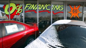 A 0% financing sign on a car dealership window.