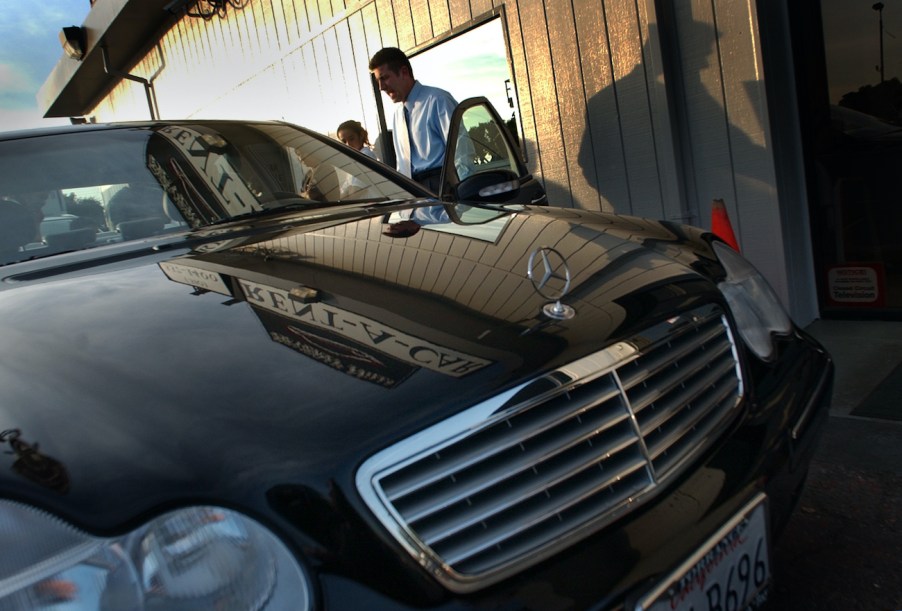 Agent Alen Zare helps a customer as he checks out a Mercedes at the luxury Beverly Hills Rent A Car.