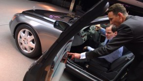 A salesman shows a customer a new car.