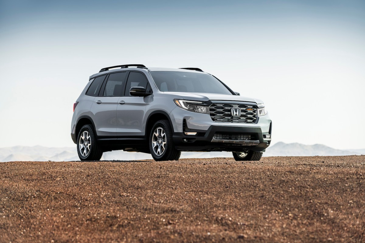 A 2022 Honda Passport TrailSport SUV parked on dirt. The Honda Passport is one of the best midsize SUVs for 2023 to buy.