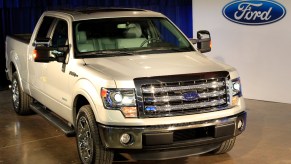 As a used full-size truck, the 2012 Ford F-150 is displayed at an auto show.