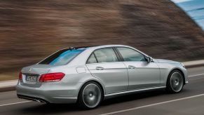 Silver 2024 Mercedes-Benz E-Class midsize sedan driving away from the camera.