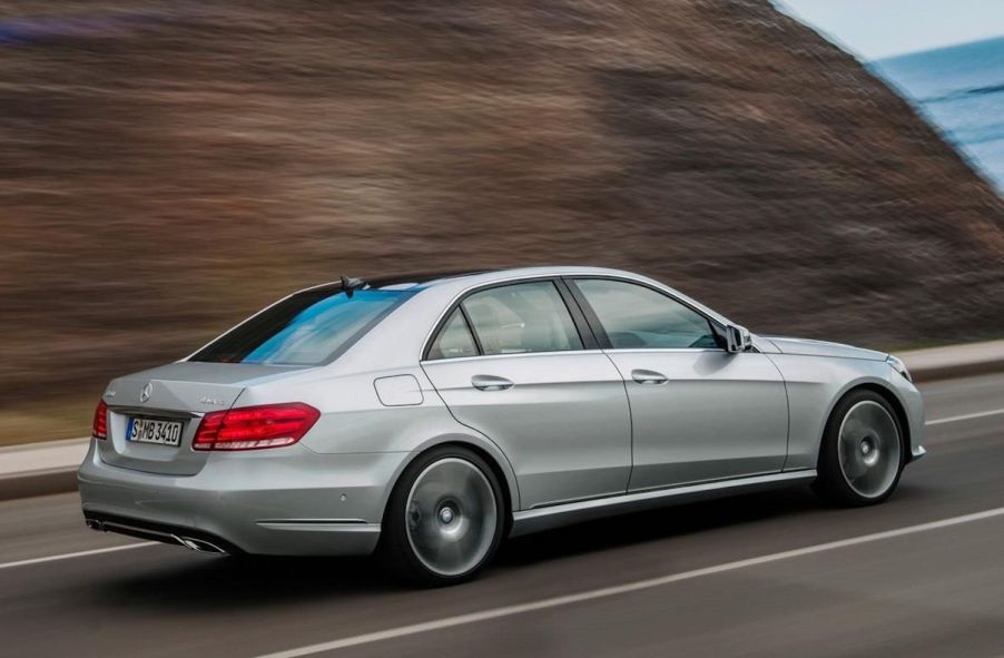 Silver 2024 Mercedes-Benz E-Class midsize sedan driving away from the camera.