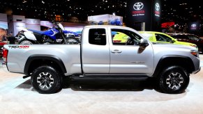 Silver 2017 Toyota Tacoma TRD 4x4 midsize pickup truck parked in a row of vehicles at an auto show.