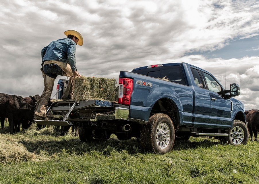 Promo photo of a blue Ford Super Duty pickup truck parked in a field.