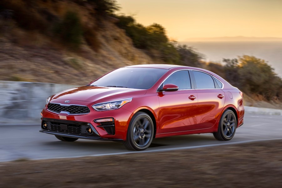 A red 2019 Kia Forte used car parked at dusk