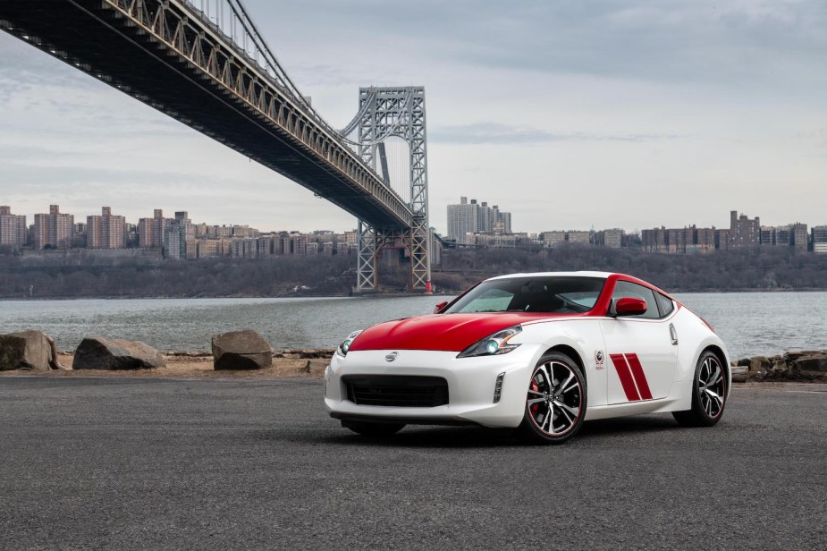 A red and white 2020 Nissan 370Z 50th Anniversary Edition parked near a bridge