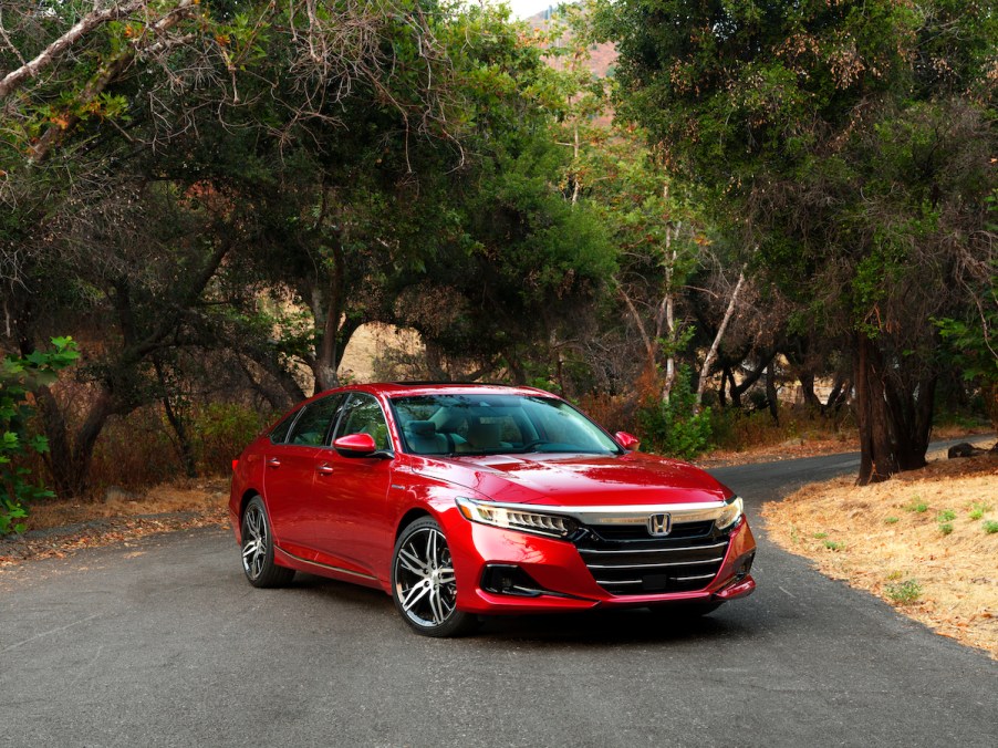 A red 2022 Honda Accord Hybrid parked in a driveway