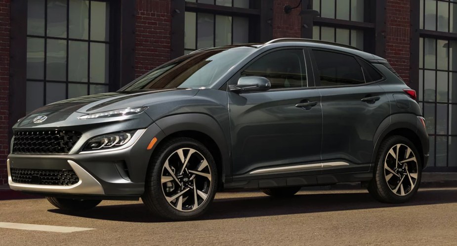 A black 2023 Hyundai Kona subcompact SUV is parked outside. 