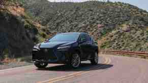 A dark grey 2022 Lexus NX 350 luxury SUV driving