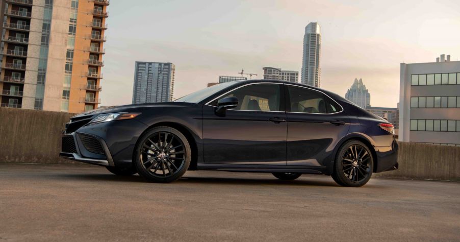 A 2022 Toyota Camry XSE midsize sedan model in Blueprint parked on a city parking garage roof top