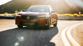 A red 2023 Acura Integra A-Spec driving in the sun