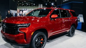 A red 2023 Chevrolet Tahoe parked indoors.