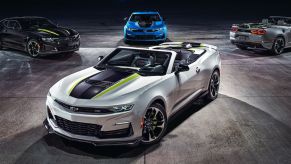 A collection of 2023 Chevy Camaro sports car/muscle car models parked on a concrete floor