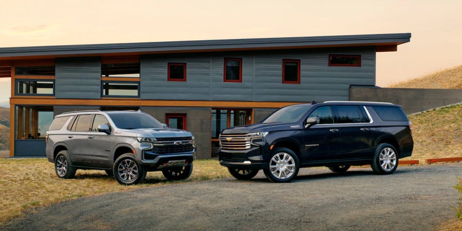 A 2023 Chevy Tahoe parked next to a Suburban. The full-size SUV family from Chevrolet.