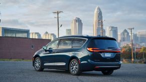 A 2023 Chrysler Pacifica Hybrid Pinnacle plug-in hybrid electric vehicle (PHEV) minivan model parked on asphalt