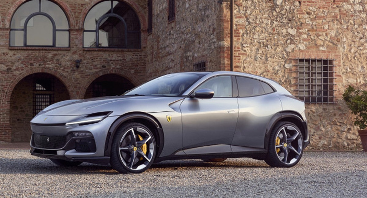 A gray 2023 Ferrari Purosangue luxury performance SUV is parked outside.