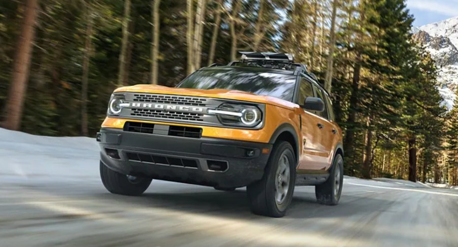 A yellow 2023 Ford Bronco Sport is driving on the road.