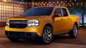 A yellow 2023 Ford Maverick small pickup truck is parked outside.