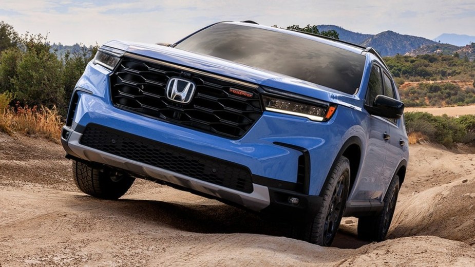 Light Blue 2023 Honda Pilot TrailSport Playing on dirt trails