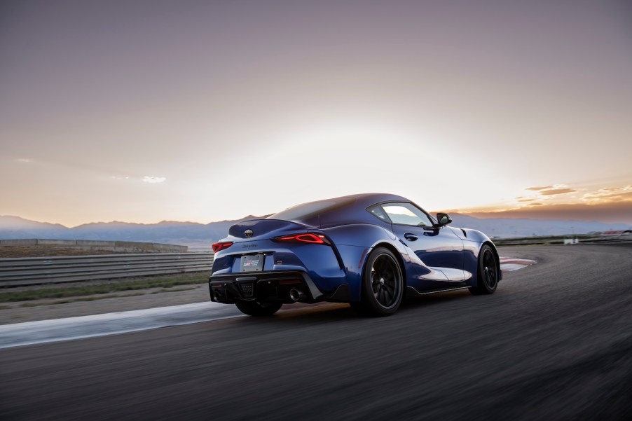 A blue 2023 Toyota GR Supra driving in the distance