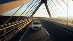 A 2023 Toyota Prius driving across a bridge