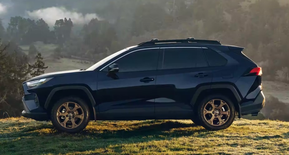 A blue 2023 Toyota RAV4 is parked outside. 