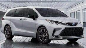 A gray 2023 Toyota Sienna minivan is parked.