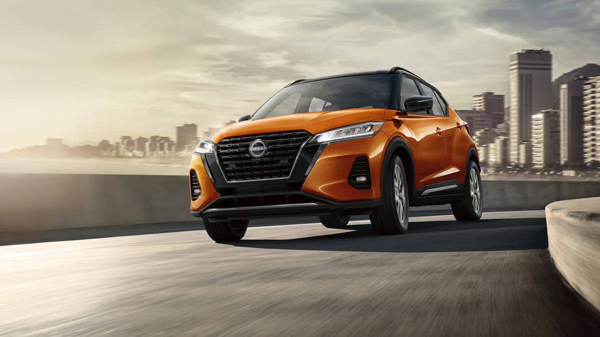 An orange 2023 Nissan Kicks shows off as a cheap SUV.