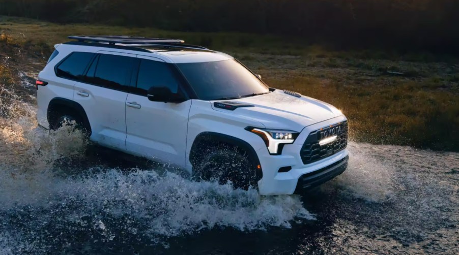 A 2023 Toyota Sequoia TRD Pro hybrid SUV navigates a watery terrain.