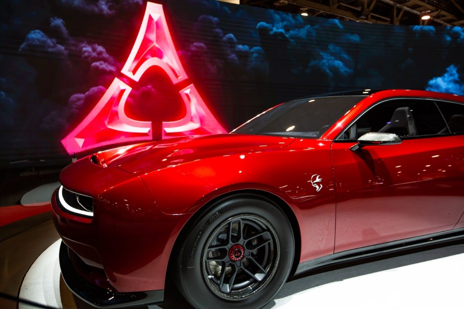 The fender and SRT Banshee badge of a red Dodge Charger Daytona eMuscle EV.