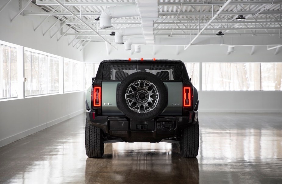 2024 GMC Hummer EV taillights while parked in a while room with many windows.