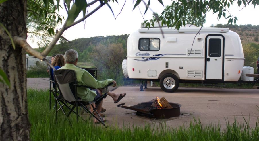 The Casita Independence travel trailer parked on the side of a road with a fireplace constructed