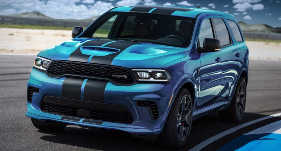 A blue 2023 Dodge Durango SRT Hellcat is driving on a track.