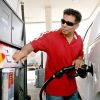 A man refueling his Ford F-150 at a Shell gas station in Houston, Texas