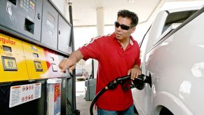 A man refueling his Ford F-150 at a Shell gas station in Houston, Texas