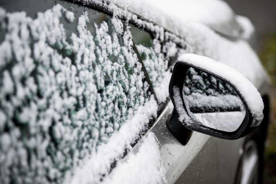 A snow covered car that is showing the effects winter weather has on your car you may not think about.