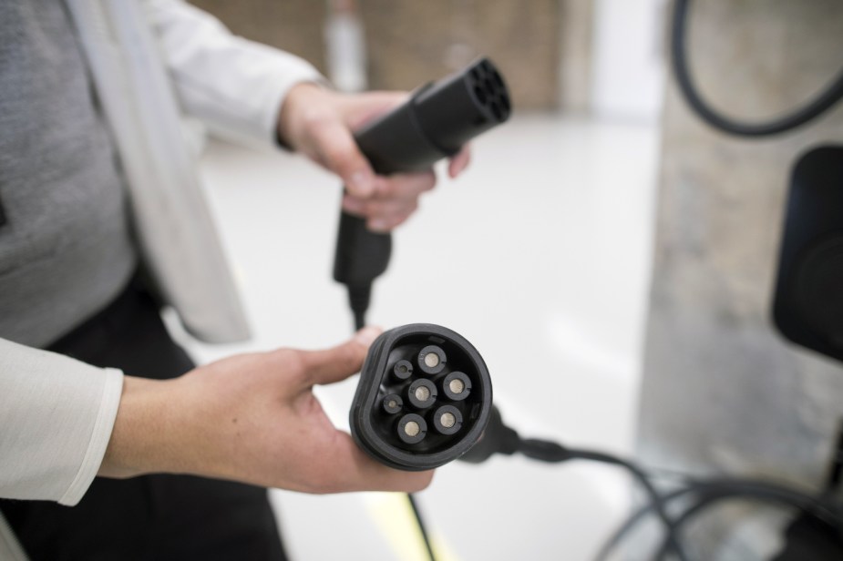 Closeup of the plug end of a Polestar electric car's EV charging cable, showing how its prongs differ from a dryer outlet.