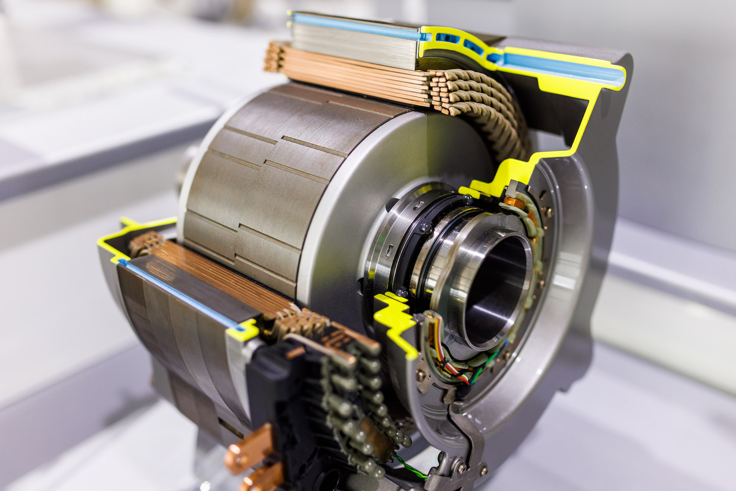 A cutaway model of a high-torque electric motor, its rotors visible, sitting on a stand in a museum.