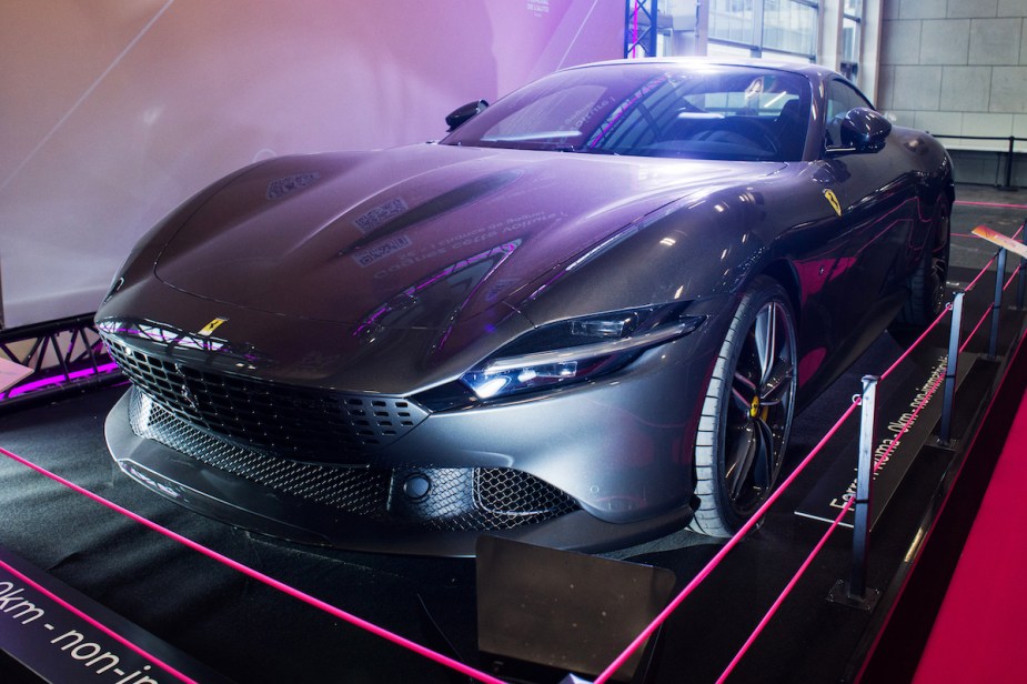 A Ferrari high performance car parked indoors. 