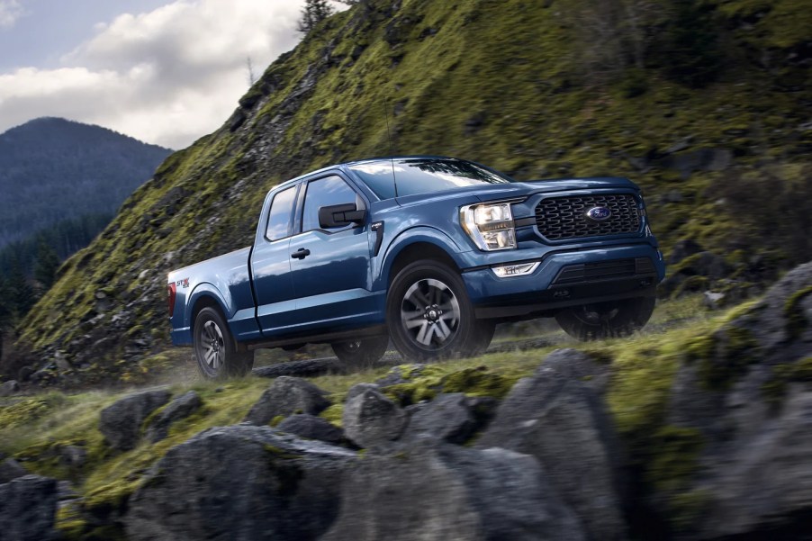 A 2023 Ford F-150 SuperCab cruises on a mountian road.