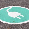 A charging sign painted on a parking spot for electric vehicles.