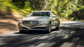 A Genesis G90 luxury sedan driving