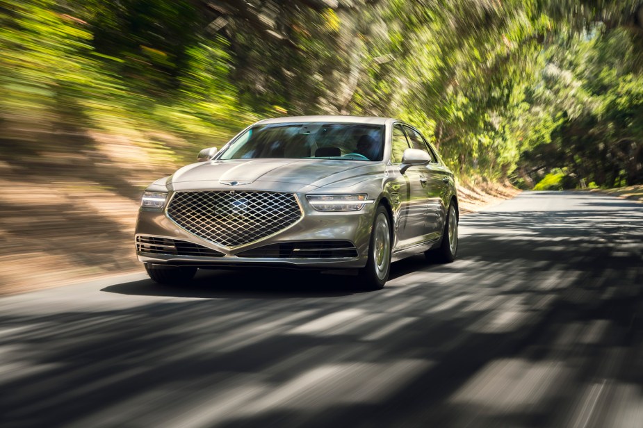 A Genesis G90 luxury sedan driving