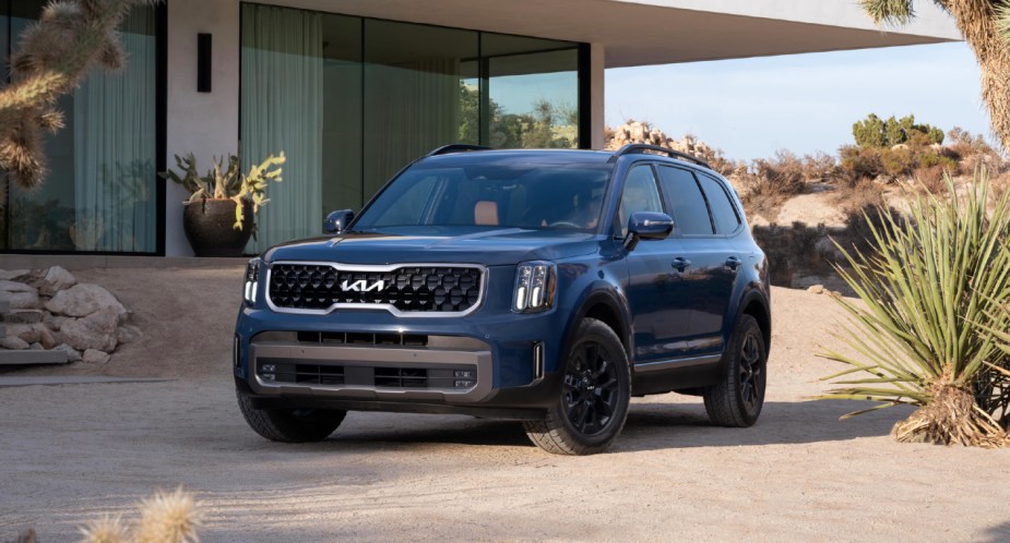 A blue 2023 Kia Telluride midsize SUV is parked. 