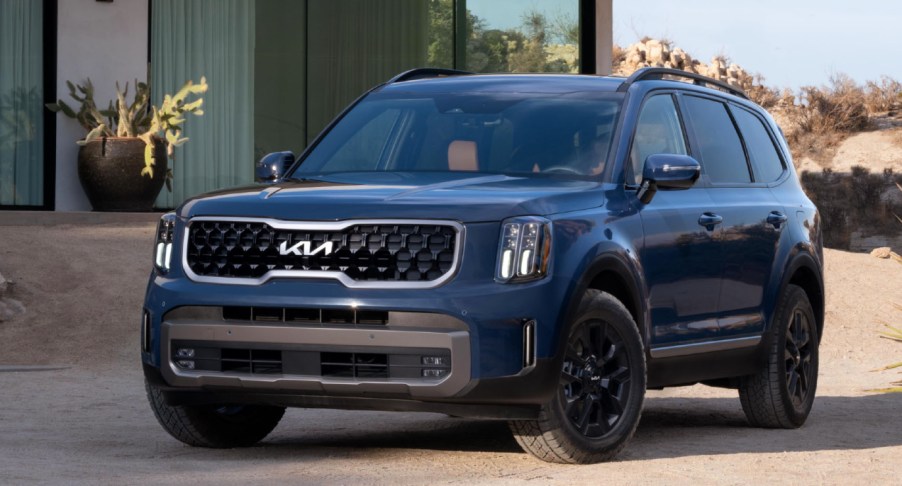 A blue 2023 Kia Telluride midsize SUV is parked.